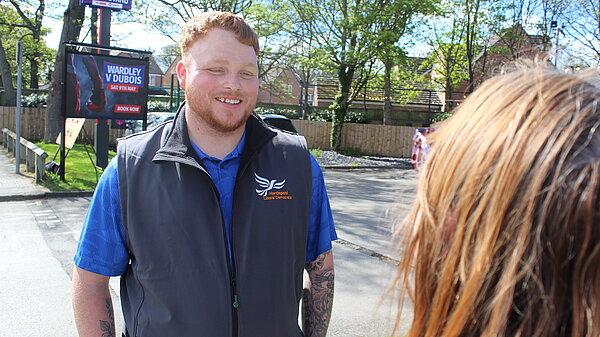 Connor Stallard speaking to a resident