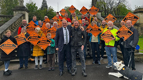 Ed Davey and Lib Dems with placards celebrate 2026 elections results