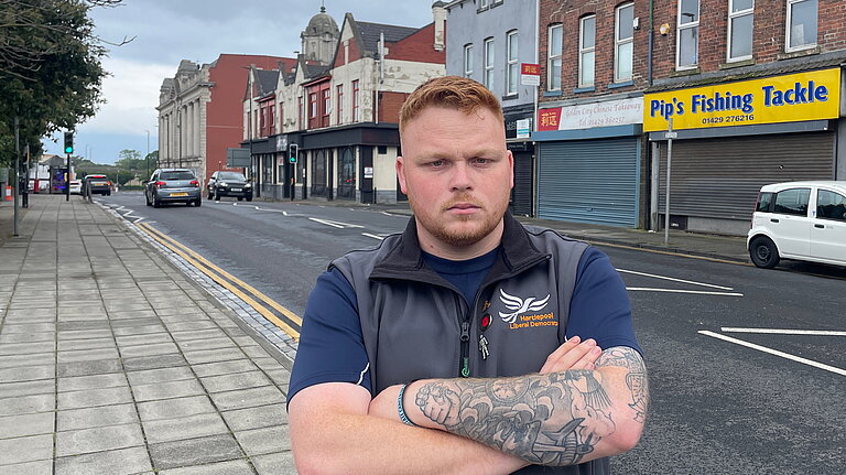 Connor Stallard infront of local shops in Hartlepool